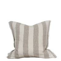 Striped pillow on a wooden surface with a white background