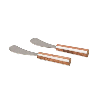 Two metal spreaders with wooden handles on a light gray surface