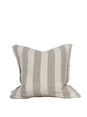 Striped pillow on a wooden surface with a white background